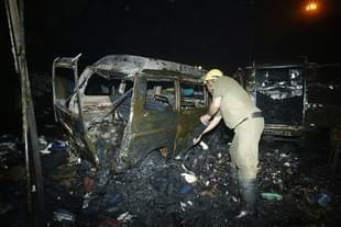 An Indian policeman inspects the wreckage of a vehicle following a blast at Sarojini Nagar market, 29 October 2005 in New Delhi. (RAVEENDRAN/AFP/Getty Images)